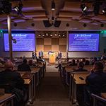 An audience watches a group of panelists give a presentation on stage at Central Florida's Second Annual Immersive 技术 Summit.